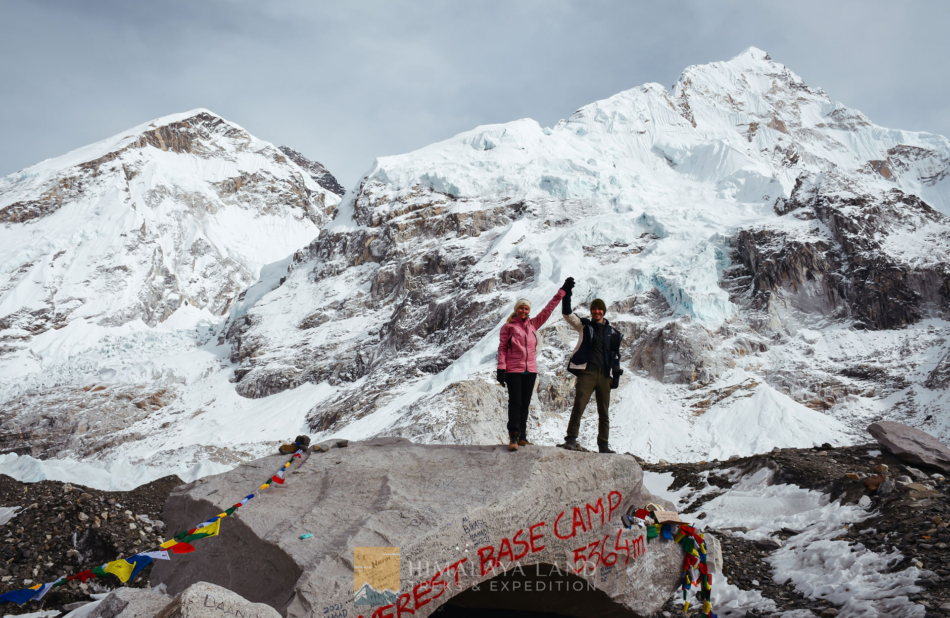 client celebrates their incredible achievement at the Everest Base Camp Summit.